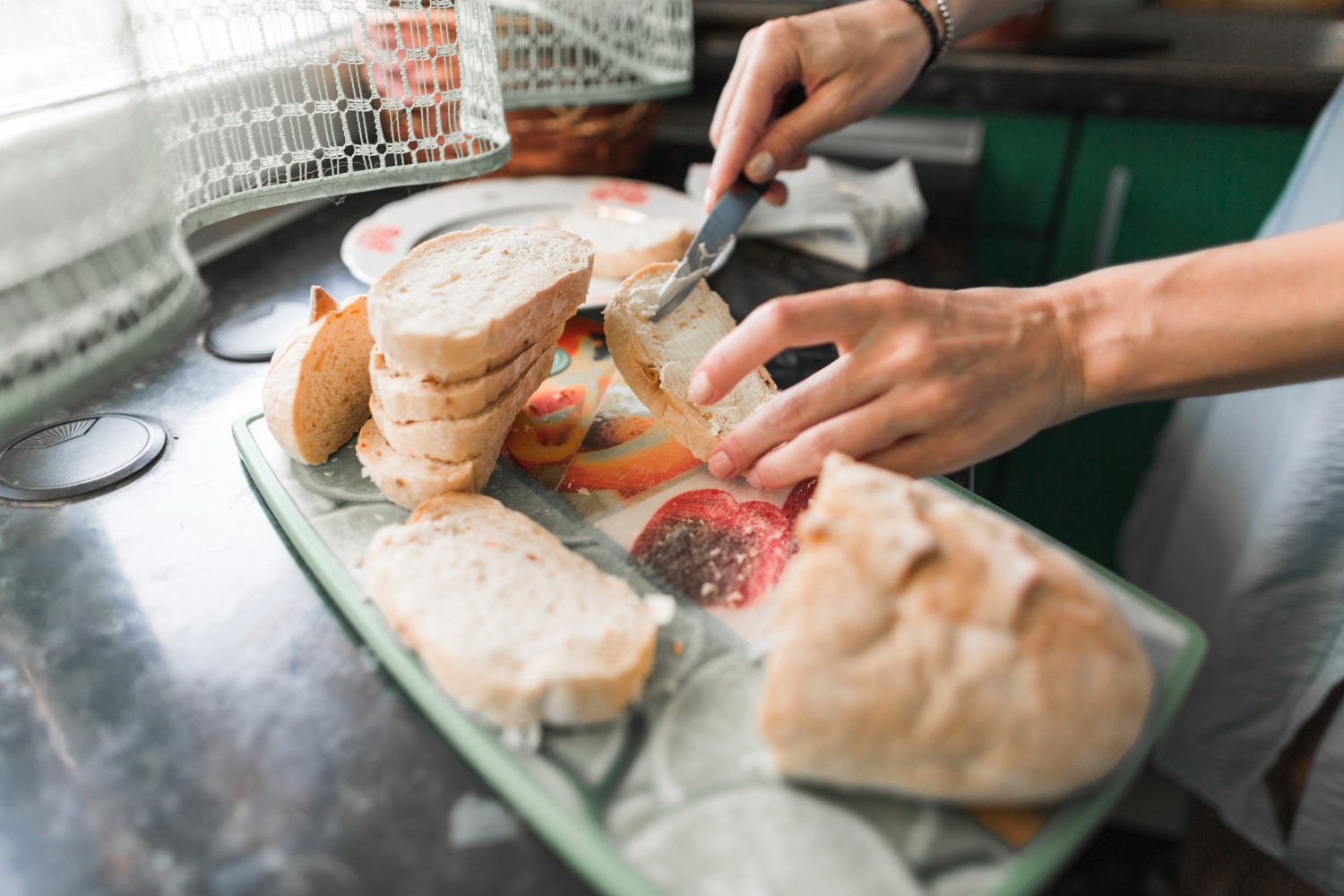 close-up-of-a-person-applying-cheese-to-slices-of-bread.jpg